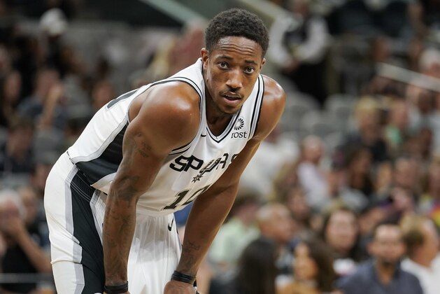 San Antonio Spurs' DeMar DeRozan pauses on the court between plays in the second half of the team's NBA preseason basketball game against the Detroit Pistons, Friday, Oct. 5, 2018, in San Antonio. San Antonio won 117-93. (AP Photo/Darren Abate)