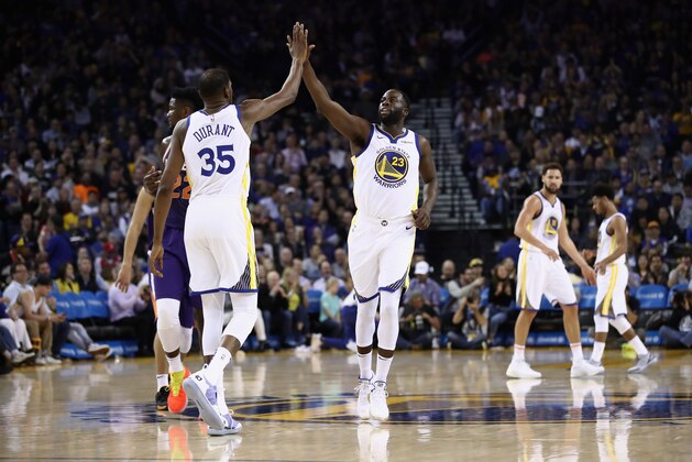 OAKLAND, CA - OCTOBER 22:  Draymond Green #23 of the Golden State Warriors high fives Kevin Durant #35 after making a basket against the Phoenix Suns at ORACLE Arena on October 22, 2018 in Oakland, California. NOTE TO USER: User expressly acknowledges and agrees that, by downloading and or using this photograph, User is consenting to the terms and conditions of the Getty Images License Agreement.  (Photo by Ezra Shaw/Getty Images)