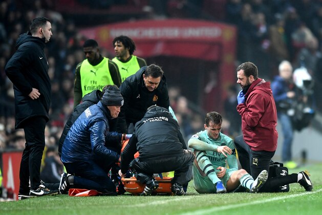 MANCHESTER, ENGLAND - DECEMBER 05:  Rob Holding of Arsenal receives medical treatment during the Premier League match between Manchester United and Arsenal FC at Old Trafford on December 5, 2018 in Manchester, United Kingdom.  (Photo by Michael Regan/Getty Images)