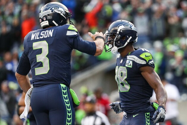 SEATTLE, WA - DECEMBER 02: Jaron Brown #18 of the Seattle Seahawks celebrates a touchdown with Russell Wilson #3 in the third quarter against the San Francisco 49ers at CenturyLink Field on December 2, 2018 in Seattle, Washington. (Photo by Abbie Parr/Getty Images)