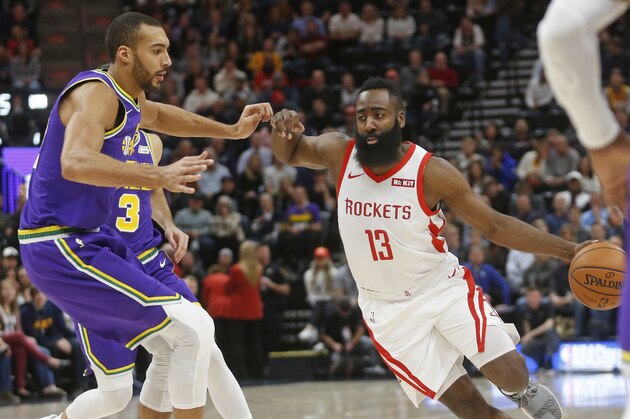 Houston Rockets guard James Harden (13) drives around Utah Jazz center Rudy Gobert, left, during the first half of an NBA basketball game Thursday Dec. 6, 2018, in Salt Lake City. (AP Photo/Rick Bowmer)