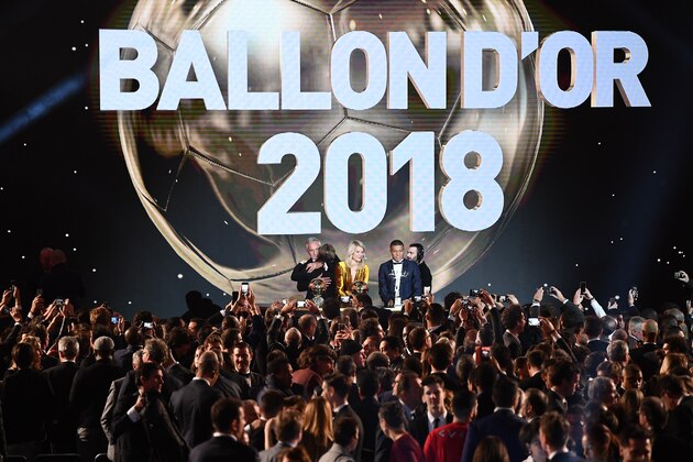 2018  Ballon d'Or awarded for best player of the year, Men's Ballon d'Or Real Madrid's Croatian midfielder Luka Modric (2ndL) is congratulated by former French footballer and host David Ginola (L) past Women's Ballon d'Or Olympique Lyonnais' Norwegian forward Ada Hegerberg (C) and Under-21 Ballon d'Or (Kopa trophy) Paris Saint-Germain's French forward Kylian Mbappe (2ndR) at the end of the 2018 Ballon d'Or award ceremony at the Grand Palais in Paris on December 3, 2018. (Photo by FRANCK FIFE / AFP)        (Photo credit should read FRANCK FIFE/AFP/Getty Images)