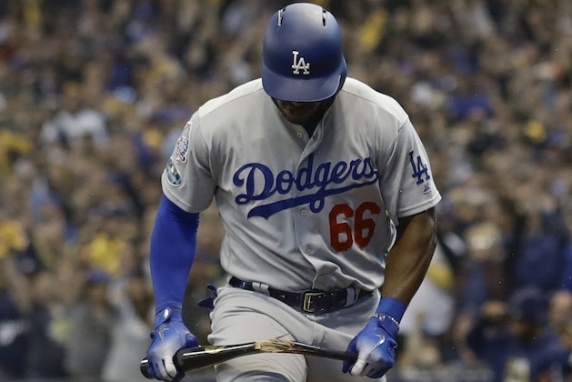 Los Angeles Dodgers' Yasiel Puig breaks his bat after striking out with bases loaded during the seventh inning of Game 2 of the National League Championship Series baseball game Saturday, Oct. 13, 2018, in Milwaukee. (AP Photo/Jeff Roberson)