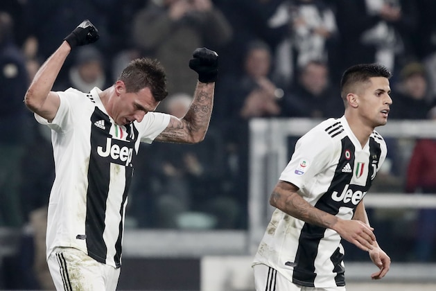 Juventus' Croatian forward Mario Mandzukic (L) celebrates with Juventus' Portuguese defender Joao Cancelo after scoring during the Serie A football match Juventus vs Inter Milan at the Stadio delle Alpi in Turin on December 7, 2018. (Photo by Isabella BONOTTO / AFP)        (Photo credit should read ISABELLA BONOTTO/AFP/Getty Images)