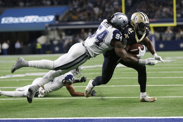 New Orleans Saints running back Alvin Kamara (41) is hit by Dallas Cowboys middle linebacker Jaylon Smith (54) and stopped short of the goal line in the first half of an NFL football game, in Arlington, Texas, Thursday, Nov. 29, 2018. (AP Photo/Ron Jenkins)