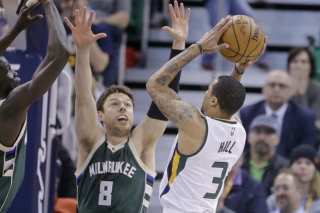 Utah Jazz guard George Hill (3) shoots as Milwaukee Bucks guard Matthew Dellavedova (8) defends in the first half during an NBA basketball game, Wednesday, Feb. 1, 2017, in Salt Lake City. (AP Photo/Rick Bowmer)
