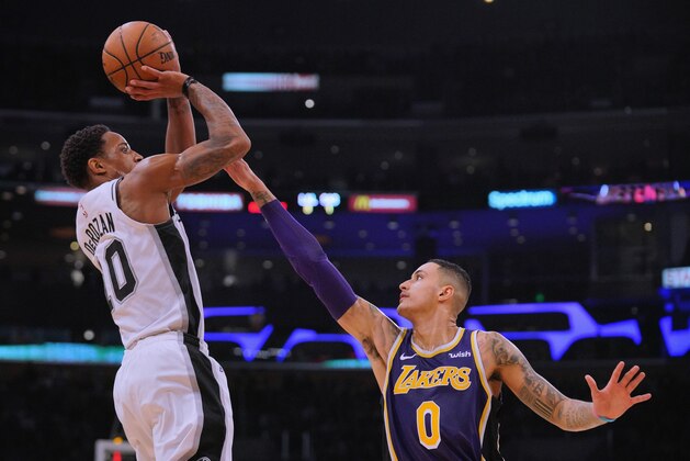 LOS ANGELES, CA - DECEMBER 05:  DeMar DeRozan #10 of the San Antonio Spurs scores on a jumper over Kyle Kuzma #0 of the Los Angeles Lakers during a 121-113 Laker win at Staples Center on December 5, 2018 in Los Angeles, California.  NOTE TO USER: User expressly acknowledges and agrees that, by downloading and or using this photograph, User is consenting to the terms and conditions of the Getty Images License Agreement.  (Photo by Harry How/Getty Images)