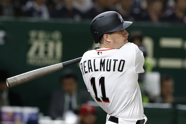 MLB All-Star catcher J.T. Realmuto of the Miami Marlins watches the flight of his three-run home-run off All Japan's pitcher Masaru Sato in the eighth inning of Game 2 of their All-Stars Series baseball at Tokyo Dome in Tokyo, Saturday, Nov. 10, 2018. (AP Photo/Toru Takahashi)