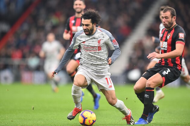 Bournemouth's English defender Steve Cook (R) challenges Liverpool's Egyptian midfielder Mohamed Salah in the build-up to Salah scoring his and Liverpool's second goal during the English Premier League football match between Bournemouth and Liverpool at the Vitality Stadium in Bournemouth, southern England on December 8, 2018. (Photo by Glyn KIRK / AFP) / RESTRICTED TO EDITORIAL USE. No use with unauthorized audio, video, data, fixture lists, club/league logos or 'live' services. Online in-match use limited to 120 images. An additional 40 images may be used in extra time. No video emulation. Social media in-match use limited to 120 images. An additional 40 images may be used in extra time. No use in betting publications, games or single club/league/player publications. /         (Photo credit should read GLYN KIRK/AFP/Getty Images)