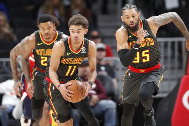Atlanta Hawks' Trae Young (11), Kent Bazemore, and DeAndre' Bembry (95) run down court during the first half of an NBA basketball game against the Washington Wizards Wednesday, Dec. 5, 2018, in Atlanta. (AP Photo/John Bazemore)