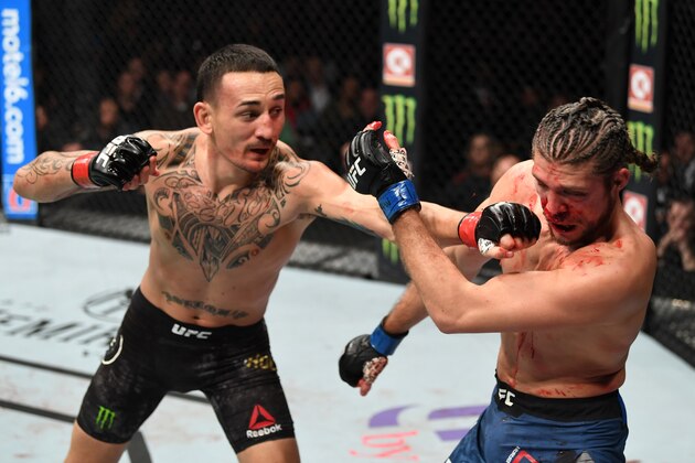 TORONTO, CANADA - DECEMBER 08:  (L-R) Max Holloway punches Brian Ortega in their UFC featherweight championship fight during the UFC 231 event at Scotiabank Arena on December 8, 2018 in Toronto, Canada. (Photo by Josh Hedges/Zuffa LLC/Zuffa LLC via Getty Images)