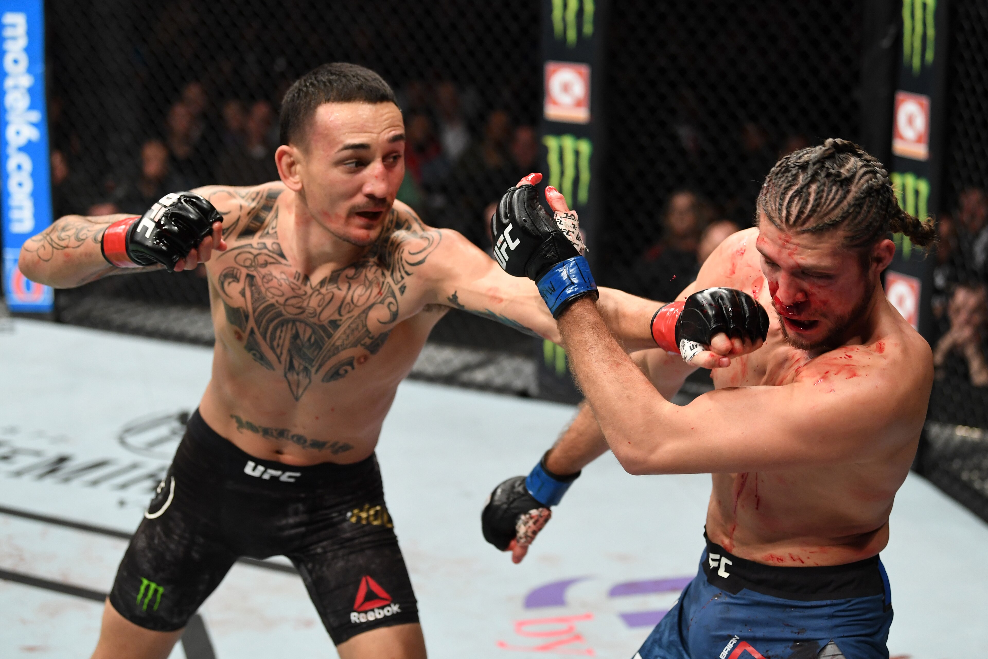 TORONTO, CANADA - DECEMBER 08:  (L-R) Max Holloway punches Brian Ortega in their UFC featherweight championship fight during the UFC 231 event at Scotiabank Arena on December 8, 2018 in Toronto, Canada. (Photo by Josh Hedges/Zuffa LLC/Zuffa LLC via Getty Images)