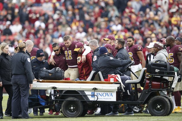 LANDOVER, MD - NOVEMBER 18: Alex Smith #11 of the Washington Redskins is helped off the field after being sacked and injured by Kareem Jackson #25 of the Houston Texans in the third quarter of the game at FedExField on November 18, 2018 in Landover, Maryland. (Photo by Joe Robbins/Getty Images)
