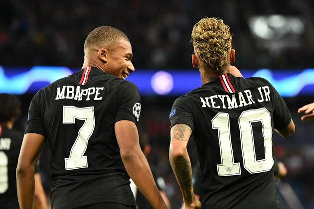 Paris Saint-Germain's French forward Kylian MBappe (L) and Paris Saint-Germain's Brazilian forward Neymar react during the UEFA Champions' League football match Paris Saint Germain (PSG) against Red Star Belgrade at the Parc des Princes stadium in Paris on October 3, 2018. (Photo by FRANCK FIFE / AFP)        (Photo credit should read FRANCK FIFE/AFP/Getty Images)