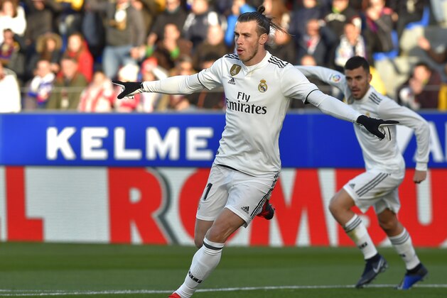 Real Madrid's Welsh forward Gareth Bale (C) celebrates after scoring his team's first goal during the Spanish league football match between SD Huesca and Real Madrid CF at the El Alcoraz stadium on December 9, 2018. (Photo by ANDER GILLENEA / AFP)        (Photo credit should read ANDER GILLENEA/AFP/Getty Images)
