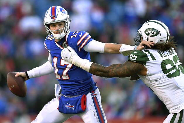 Buffalo Bills quarterback Josh Allen (17) tries to fend off New York Jets defensive end Leonard Williams (92) during the second half of an NFL football game, Sunday, Dec. 9, 2018, in Orchard Park, N.Y. (AP Photo/Adrian Kraus)