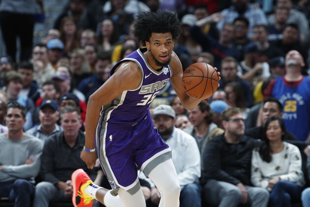 Sacramento Kings forward Marvin Bagley III picks up a loose ball and heads down the court against the Denver Nuggets in the first half of an NBA basketball game, Tuesday, Oct. 23, 2018, in Denver. (AP Photo/David Zalubowski)