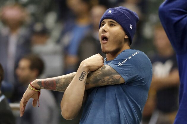 Los Angeles Dodgers' Manny Machado stretches as he takes batting practice before Game 6 of the National League Championship Series baseball game against the Milwaukee Brewers Friday, Oct. 19, 2018, in Milwaukee. (AP Photo/Jeff Roberson)