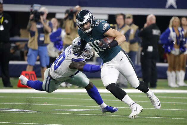 Philadelphia Eagles' Dallas Goedert (88) escapes a tackle attempt by Dallas Cowboys defensive end DeMarcus Lawrence (90) in the second half of an NFL football game in Arlington, Texas, Sunday, Dec. 9, 2018. (AP Photo/Michael Ainsworth)