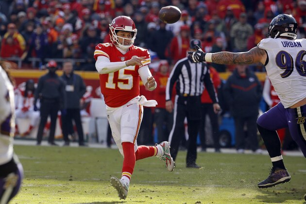 Kansas City Chiefs quarterback Patrick Mahomes (15) throws on the run past Baltimore Ravens defensive end Brent Urban (96) during the first half of an NFL football game in Kansas City, Mo., Sunday, Dec. 9, 2018. (AP Photo/Charlie Riedel)
