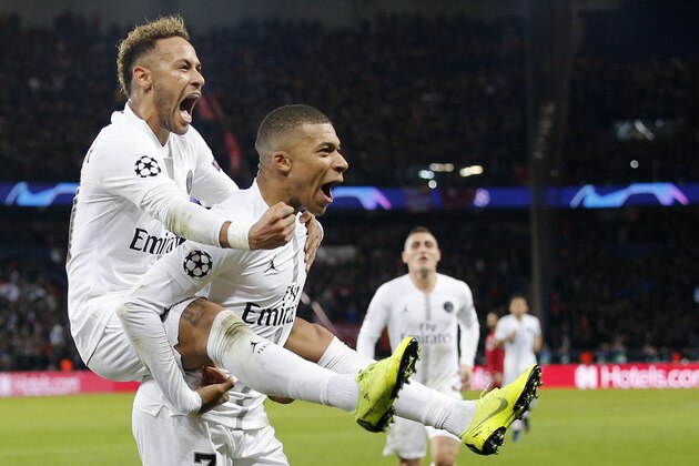 PSG's Neymar, left, celebrates with teammate Kylian Mbappe his side's second goal during the Champions League Group C second leg soccer match between Paris Saint Germain and Liverpool at the Parc des Princes stadium in Paris, Wednesday, Nov. 28, 2018. (AP Photo/Thibault Camus)