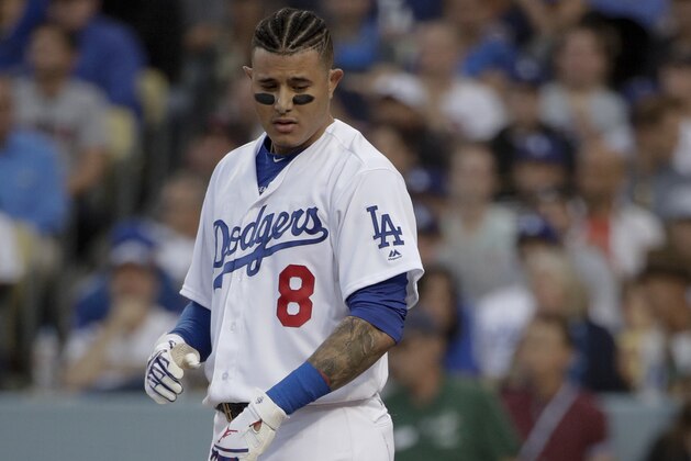 Los Angeles Dodgers' Manny Machado throws his helmet after striking out against the Boston Red Sox during the first inning in Game 5 of the World Series baseball game on Sunday, Oct. 28, 2018, in Los Angeles. (AP Photo/Jae C. Hong)