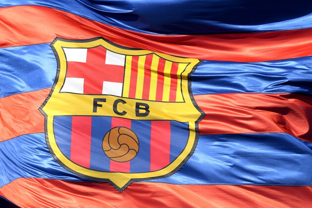 BARCELONA, SPAIN - APRIL 04:  The Barcelona logo is seen on a flag waving above the stadium prior to the UEFA Champions League Quarter Final Leg One match between FC Barcelona and AS Roma at Camp Nou on April 4, 2018 in Barcelona, Spain.  (Photo by Mike Hewitt/Getty Images)