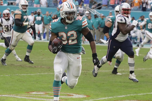 Miami Dolphins running back Kenyan Drake (32) runs for a touchdown during the second half of an NFL football game against the New England Patriots, Sunday, Dec. 9, 2018, in Miami Gardens, Fla. The Dolphins defeated the Patriots 34-33. (AP Photo/Lynne Sladky)