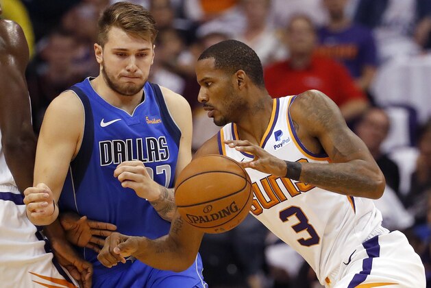 Phoenix Suns forward Trevor Ariza (3) dries past Dallas Mavericks guard Luka Doncic during the first half of an NBA basketball game, Wednesday, Oct. 17, 2018, in Phoenix. (AP Photo/Matt York)