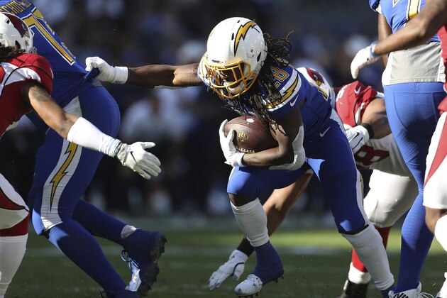 Los Angeles Chargers running back Melvin Gordon (28) runs up the middle behind a lineman in the first half of an NFL football game, Sunday, Nov. 25, 2018, in Carson, Calif. (AP Photo/Peter Joneleit)
