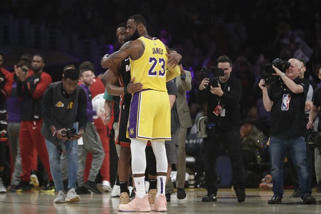 Los Angeles Lakers forward LeBron James (23) hugs ex teammate and current Miami Heat player Dwyane Wade during the first half of an NBA basketball game Monday, Dec. 10, 2018, in Los Angeles. (AP Photo/Marcio Jose Sanchez)