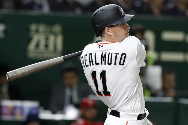 MLB All-Star catcher J.T. Realmuto of the Miami Marlins watches the flight of his three-run home-run off All Japan's pitcher Masaru Sato in the eighth inning of Game 2 of their All-Stars Series baseball at Tokyo Dome in Tokyo, Saturday, Nov. 10, 2018. (AP Photo/Toru Takahashi)