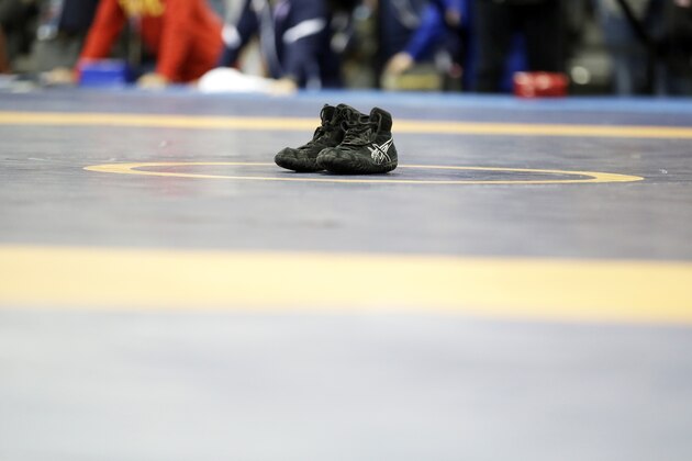 Spenser Mango's shoes sit on the center of the mat after losing to Jesse Thielke in their 59-kilogram Greco Roman match at the U.S. Olympic Wrestling Team Trials, Saturday, April 9, 2016, in Iowa City, Iowa. (AP Photo/Charlie Neibergall)
