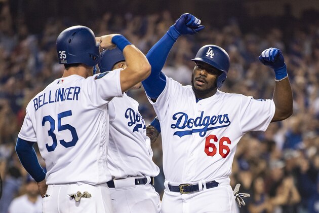 LOS ANGELES, CA - OCTOBER 27: Yasiel Puig #66 of the Los Angeles Dodgers reacts with Cody Bellinger #35 after hitting a three run home run during the sixth inning of game four of the 2018 World Series against the Boston Red Sox on October 27, 2018 at Dodger Stadium in Los Angeles, California. (Photo by Billie Weiss/Boston Red Sox/Getty Images)