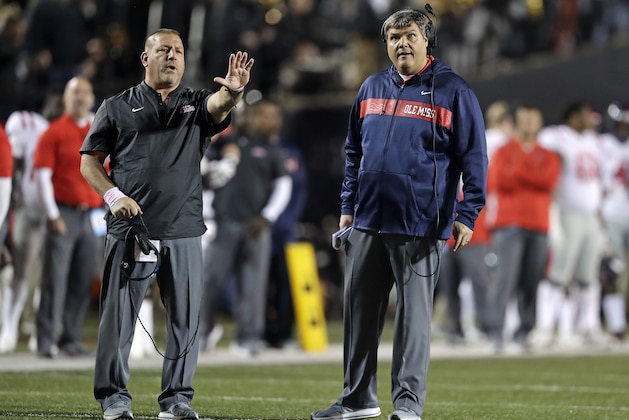 Mississippi head coach Matt Luke, right, and offensive coordinator Phil Longo, left, direct players in the first half of an NCAA college football game between Mississippi and Vanderbilt Saturday, Nov. 17, 2018, in Nashville, Tenn. (AP Photo/Mark Humphrey)