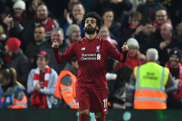 Liverpool's Egyptian midfielder Mohamed Salah celebrates scoring the opening goal during the UEFA Champions League group C football match between Liverpool and Napoli at Anfield stadium in Liverpool, north west England on December 11, 2018. (Photo by Paul ELLIS / AFP)        (Photo credit should read PAUL ELLIS/AFP/Getty Images)