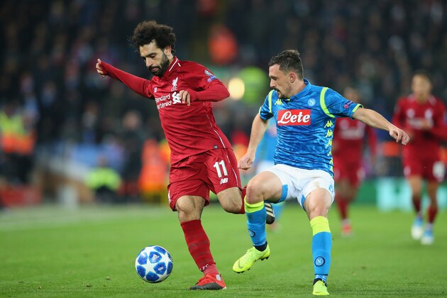 LIVERPOOL, ENGLAND - DECEMBER 11:  Mohamed Salah of Liverpool holds off a challenge from Mario Rui of SSC Napoli during the UEFA Champions League Group C match between Liverpool and SSC Napoli at Anfield on December 11, 2018 in Liverpool, United Kingdom.  (Photo by Alex Livesey - Danehouse/Getty Images)