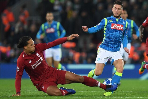 Liverpool's Dutch defender Virgil van Dijk fould Napoli's Belgian striker Dries Mertens during the UEFA Champions League group C football match between Liverpool and Napoli at Anfield stadium in Liverpool, north west England on December 11, 2018. (Photo by Paul ELLIS / AFP)        (Photo credit should read PAUL ELLIS/AFP/Getty Images)