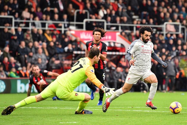 Liverpool's Egyptian midfielder Mohamed Salah (R) takes the ball around Bournemouth's Bosnian-Herzegovinian goalkeeper Asmir Begovic (L) in the build-up to scoring his third goal, Liverpool's fourth during the English Premier League football match between Bournemouth and Liverpool at the Vitality Stadium in Bournemouth, southern England on December 8, 2018. (Photo by Glyn KIRK / AFP) / RESTRICTED TO EDITORIAL USE. No use with unauthorized audio, video, data, fixture lists, club/league logos or 'live' services. Online in-match use limited to 120 images. An additional 40 images may be used in extra time. No video emulation. Social media in-match use limited to 120 images. An additional 40 images may be used in extra time. No use in betting publications, games or single club/league/player publications. /         (Photo credit should read GLYN KIRK/AFP/Getty Images)