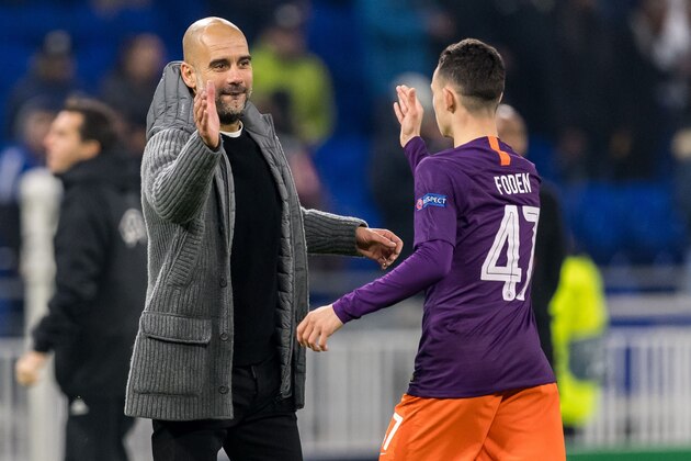 (L-R) coach Pep Guardiola of Manchester City, Phil Foden of Manchester City during the UEFA Champions League group F match between Olympique Lyonnais and Manchester City at Stade de Lyon on November 27, 2018 in Decines, France(Photo by VI Images via Getty Images)