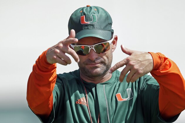 Miami defensive coordinator Manny Diaz, left, gives instructions to the players during drills at football practice, Thursday, Aug. 4, 2016, in Coral Gables, Fla. (AP Photo/Alan Diaz)