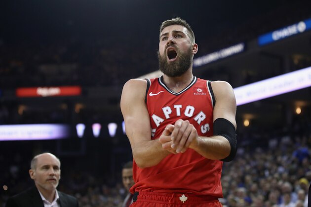 OAKLAND, CA - DECEMBER 12:  Jonas Valanciunas #17 of the Toronto Raptors grimaces in pain after hurting his finger against the Golden State Warriors at ORACLE Arena on December 12, 2018 in Oakland, California.  NOTE TO USER: User expressly acknowledges and agrees that, by downloading and or using this photograph, User is consenting to the terms and conditions of the Getty Images License Agreement.  (Photo by Ezra Shaw/Getty Images)