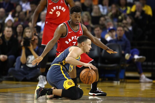 OAKLAND, CA - DECEMBER 12:  Stephen Curry #30 of the Golden State Warriors dribbles on his knees while being guarded by Kyle Lowry #7 of the Toronto Raptors at ORACLE Arena on December 12, 2018 in Oakland, California.  NOTE TO USER: User expressly acknowledges and agrees that, by downloading and or using this photograph, User is consenting to the terms and conditions of the Getty Images License Agreement.  (Photo by Ezra Shaw/Getty Images)