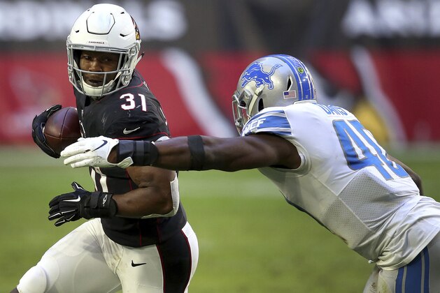 Arizona Cardinals running back David Johnson (31) is hit by Detroit Lions middle linebacker Jarrad Davis (40) during the first half of NFL football game, Sunday, Dec. 9, 2018, in Glendale, Ariz. (AP Photo/Ross D. Franklin)