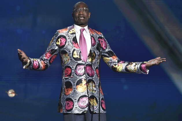 Dikembe Mutombo puts on his Sager Strong award sport coat at the NBA Awards on Monday, June 25, 2018, at the Barker Hangar in Santa Monica, Calif. (Photo by Chris Pizzello/Invision/AP)