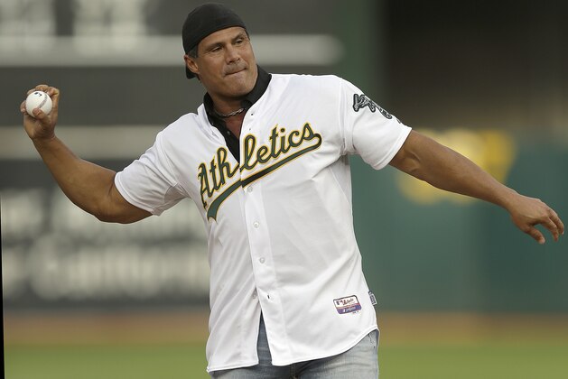FILE - In this Sept. 3, 2016, file photo, former Oakland Athletics player Jose Canseco throws out the ceremonial first pitch prior to a baseball game against the Boston Red Sox in Oakland, Calif. Canseco, a former major league slugger, has made his pitch for a big job at the White House, tweeting Wednesday, Dec. 12, 2018, to U.S. President Donald Trump: