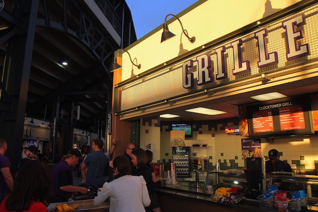 DENVER, CO - MAY 05:  Fans visit the grille on the upper concourse of the stadium as sun sets while the Atlanta Braves defeat the Colorado Rockies 13-9 at Coors Field on May 5, 2012 in Denver, Colorado.  (Photo by Doug Pensinger/Getty Images)