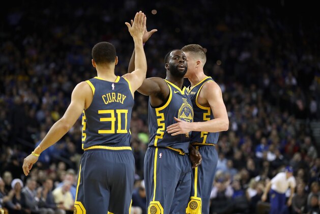OAKLAND, CA - DECEMBER 12:  Jonas Jerebko #21, Draymond Green #23, and Stephen Curry #30 of the Golden State Warriors congratulate one another after the Warriors made a basket against the Toronto Raptors at ORACLE Arena on December 12, 2018 in Oakland, California.  NOTE TO USER: User expressly acknowledges and agrees that, by downloading and or using this photograph, User is consenting to the terms and conditions of the Getty Images License Agreement.  (Photo by Ezra Shaw/Getty Images)