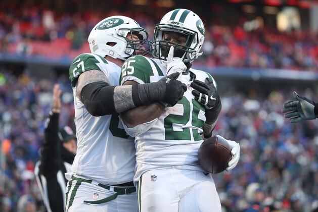 BUFFALO, NY - DECEMBER 09: Elijah McGuire #25 of the New York Jets is congratulated on his touchdown by Brian Winters #67 in the fourth quarter during NFL game action against the Buffalo Bills at New Era Field on December 9, 2018 in Buffalo, New York. (Photo by Tom Szczerbowski/Getty Images)