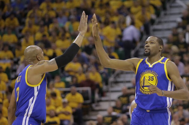 Golden State Warriors' David West (3) high fives teammate Kevin Durant (35) after he scores against the Utah Jazz in the second half during Game 4 of the NBA basketball second-round playoff series Monday, May 8, 2017, in Salt Lake City. The Warriors completed a second-round sweep of the Utah Jazz with a 121-95 victory. (AP Photo/Rick Bowmer)